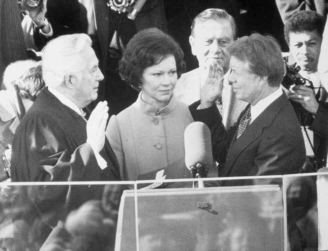 Democrat Jimmy Carter is sworn in by chief justice Earl Burger as the 39th president of the United States while first lady Rosalynn looks on, Washington DC, January 20, 1977. (Photo by Hulton Archive/Getty Images)