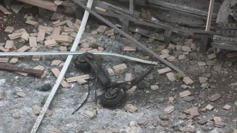 EPA-EFE/REX/Shutterstock A burnt out scooter, without its handlebars, is seen outside the apartment block where a Russian general and his assistant were killed on 17 December