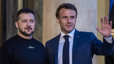 Christophe Petit Tesson/EPA-EFE/REX/Shutterstock Volodymyr Zelensky and Emmanuel Macron pose for photographers