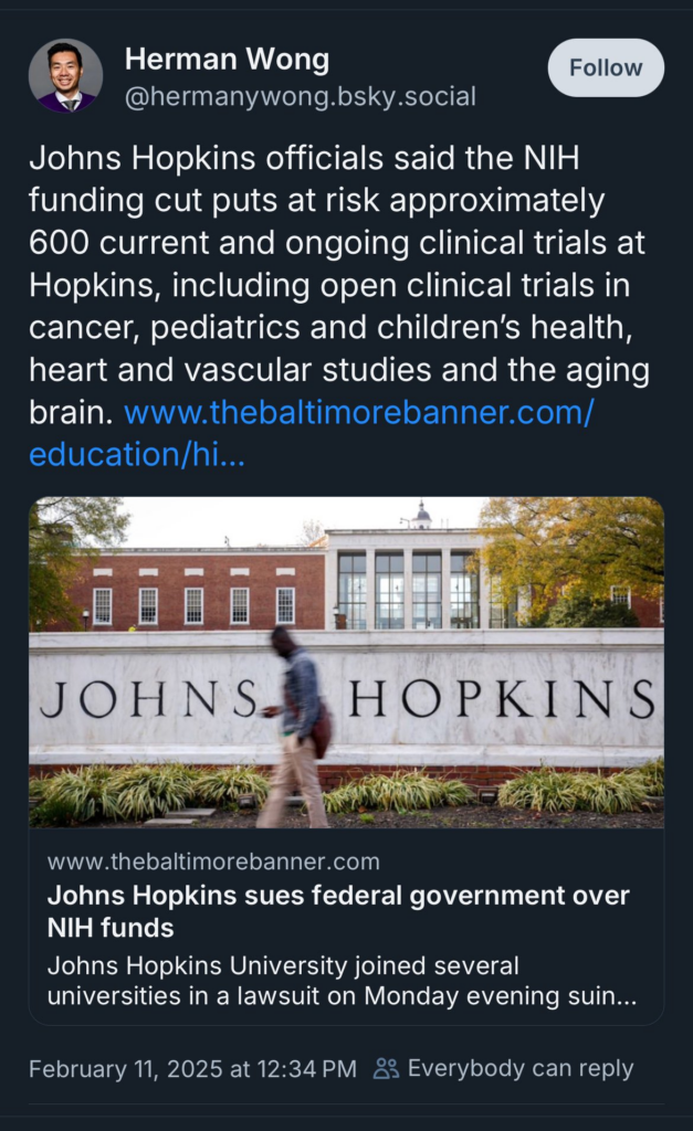 Screenshot of a social media post by Herman Wong linking to an article about Johns Hopkins suing the federal government over NIH funding cuts. The Johns Hopkins campus and a sign with the school's name are visible in the image.