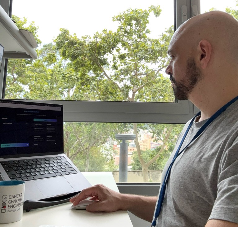 Francisco Barriga sat at a desk using a laptop computer displaying the virtual team interface.