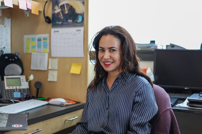 Catherine Brownstein sat at a desk with computers.