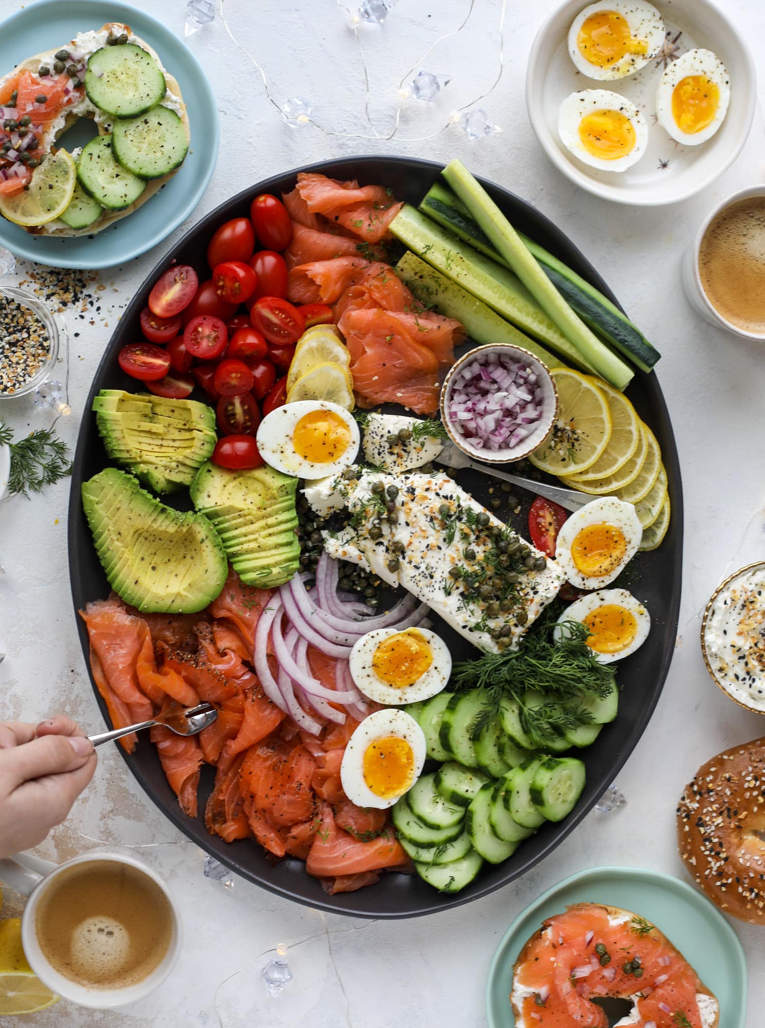 This is my favorite way to make an incredible smoked salmon platter! Fresh smoked salmon with bagels, soft boiled eggs, cream cheese and capers, everything seasoning and so much more. Perfect for holiday breakfasts and brunches! I howsweeteats.com #smokedsalmon #platter